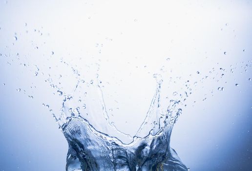 Water splash on blue abstract background