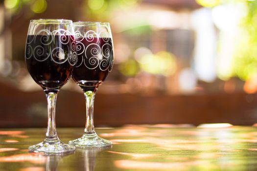 Two glasses of red wine on the table of outdoor cafe