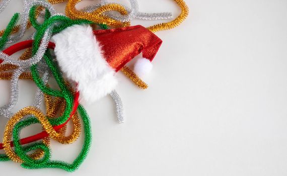 Christmas composition. Tinsel, straw toys on a white background. The concept of Christmas, winter, New year. Flat layout, top view, copy space.
