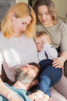 Dad with children congratulate mom on the holiday, mother's day. Have fun, laugh and give flowers