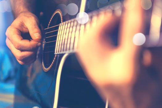 Acoustic guitar and guitarist detail