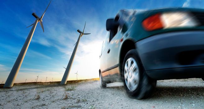 Wind mills and tire car detail.Electricity and ecology