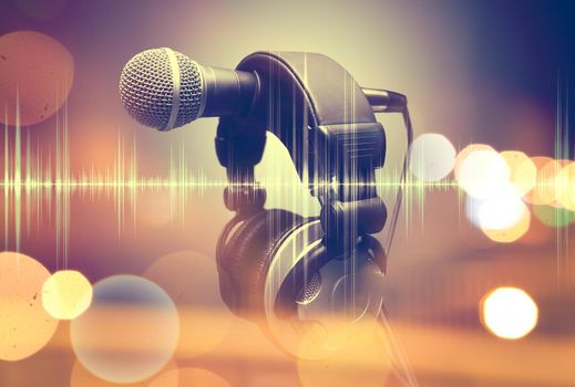 Microphone and headphones.Live music and blurred stage lights