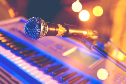 Microphone and piano  keyboard on stage.Concert and musical instrument