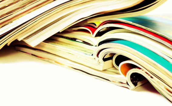 Close up image of magazines stack background. News and media publications