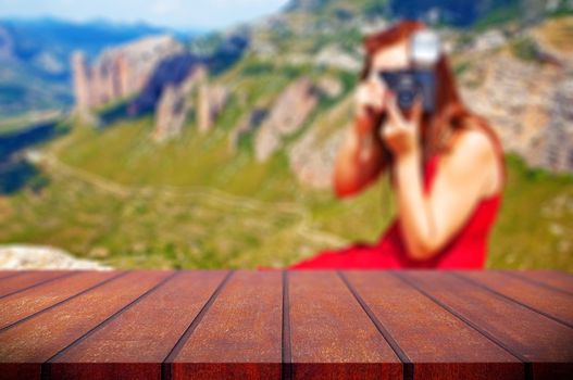 Abstract blurred background.Wooden table or counter and scenery landscape with girl taking photos