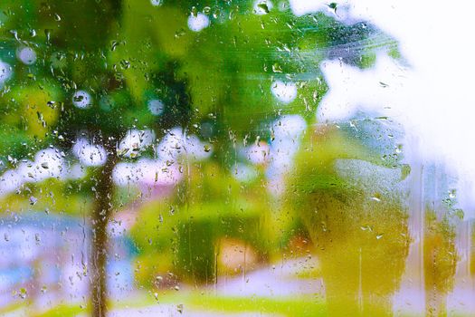 Rainy day through the wet window.Weather abstract background