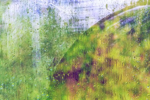 Rainy day through the wet window.Weather abstract background