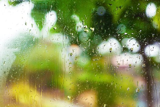 Rainy day through the wet window.Weather abstract background