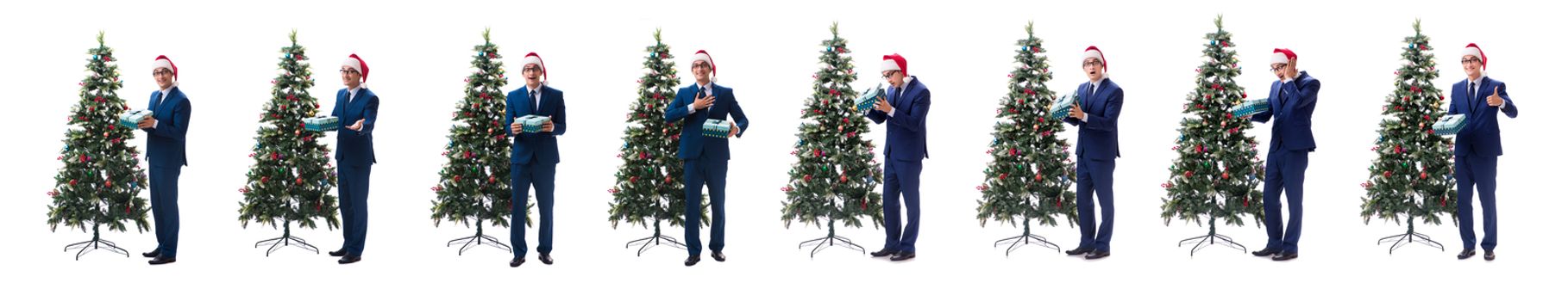 Businessman decorating christmas tree isolated on white