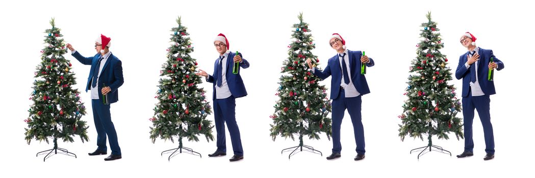 Businessman decorating christmas tree isolated on white