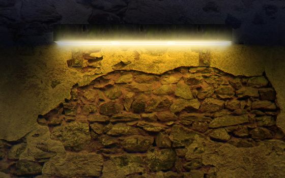 Old an ancient wall detail at night illuminated by lamp.