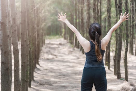 Beautiful young woman lifestyle fresh air happy relaxing in forest park