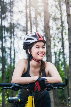 Beautiful young female woman helmet activity bicycle at forest on summer with copy space