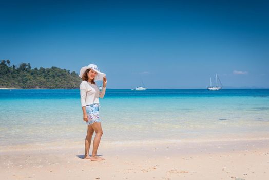 Happy young woman enjoying on beach relaxing summer at Thailand