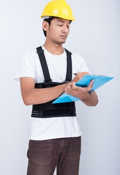 Worker Man stand write book note wearing back support belt body protect posture