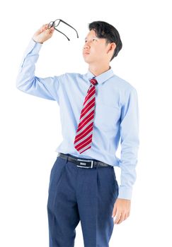 Male wearing blue shirt and red tie reaching posing in studio isolated on white background with clipping path