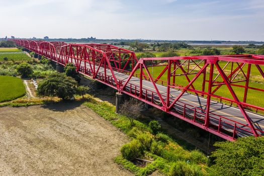 red famous Xilou Bridge over the river and farm in Yunlin county, Taiwan