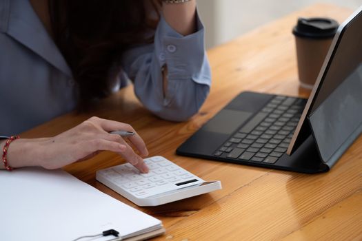 businessman working using calculator with laptop in office - accounting concept