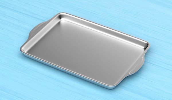 Stainless steel baking pan on wood table