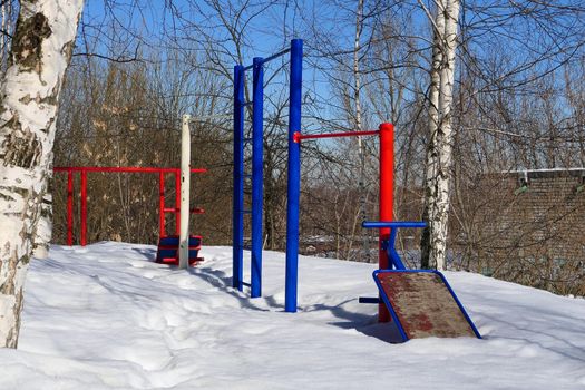 A children's or sports ground in the yard of the house in winter. High quality photo