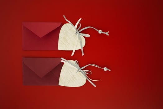 Heart medallions and envelopes on red background with free space for text. Greetings and love letter