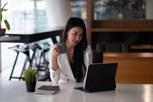 Shot of an attractive young businesswoman working on laptop in her workstation.