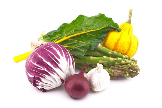 Assortment of fresh colorful including leaf beet, asparagus, radicchio salad, onion and garlic isolated on white background