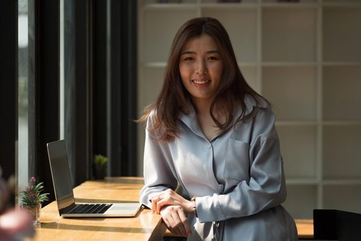 Portrait of asian businesswoman with laptop at home office.