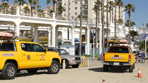 Oceanside, California USA - 8 Feb 2020: Yellow lifeguard car, beach near Los Angeles. Coastline rescue, life guard Toyota pick up truck, lifesavers vehicle. Iconic auto on ocean coast. Public safety.