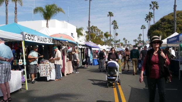 Oceanside, California USA -20 Feb 2020 People walking on marketplace, customers on farmers market. Buyers support business, vendors sell locally produced goods. Outdoor street trading stalls and tents