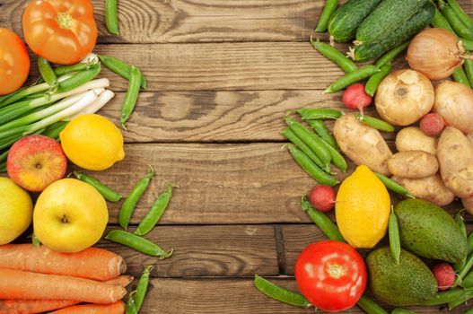 Flat lay of seasonal fruits, vegetables and herbs. Summer food concept. Healthy life and vegetarian, vegan, diet, clean food ingredients. Place for text. Food on a dark wooden background.