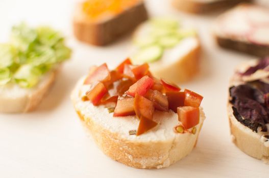 Mini sandwich set with french baguette, cheese, fish and avocado on white background top view mock up.