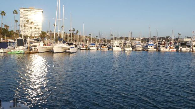 Oceanside, California USA - 27 Jan 2020: Waterfront harbor fisherman village, luxury yachts sailboats floating, marina harbour quay. Sail boat masts, nautical vessels anchored or moored in port.