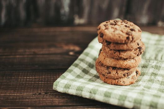 Oatmeal liver lies near the napkin in the box. Rustic table. Vintage toning. Dietary useful cookies without gluten. Copy space.