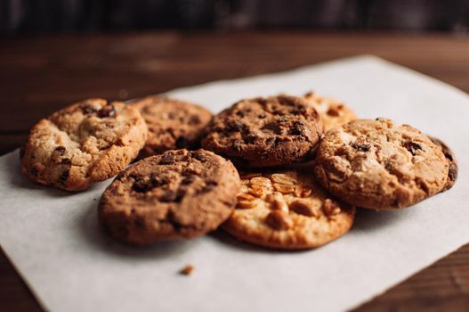 Chocolate cookies on wooden table. Chocolate chip cookies shot. Homemade food on wooden background