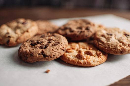 Chocolate cookies on wooden table. Chocolate chip cookies shot. Homemade food on wooden background