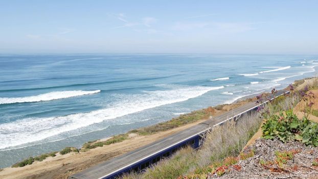 Del Mar, California USA - 23 Jan 2020: Pacific surfliner train, travel ocean beach. Passenger railroad, public transit. Express rapid intercity double decker blue commuter. Amtrak railway transport.