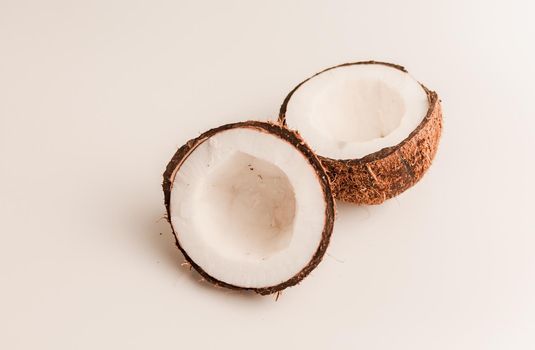 ugly organic coconut on a white background, isolate. a broken nut in a shell the white insides of a coconut, which began to decompose and covered with fungus and mold. Spoiled products.