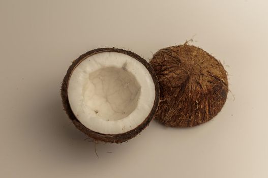 ugly organic coconut on a white background, isolate. a broken nut in a shell the white insides of a coconut, which began to decompose and covered with fungus and mold. Spoiled products.
