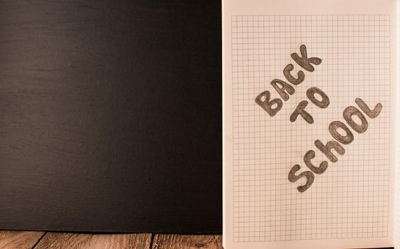 Black slate background. Back to school, the concept of parenting. Day of knowledge. The concept of education. Copy space. Rustic and vintage toning.