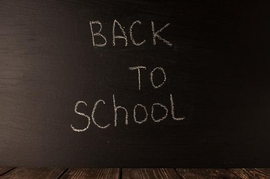 Back to school, the concept of parenting. The inscription on the blackboard with white chalk. Place for text. Copy space.