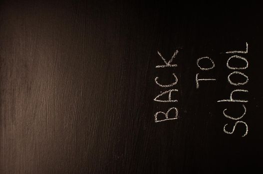 Back to school, the concept of parenting. The inscription on the blackboard with white chalk. Place for text. Copy space.