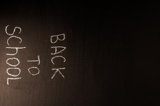 Back to school, the concept of parenting. The inscription on the blackboard with white chalk. Place for text. Copy space.