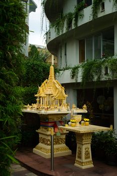 Religious offerings in a small buddhist shrine in a street of Phuket, Thailand.