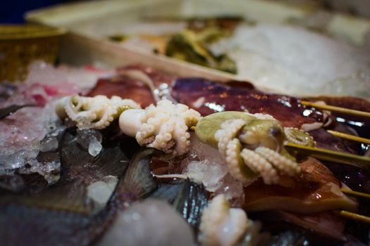 Raw octopus skewer in a market stall in Phuket, Thailand.