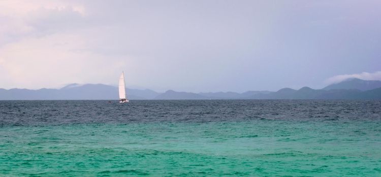 Sailboat on the turquoise waters of Andaman Sea, near Phuket, Thailand.