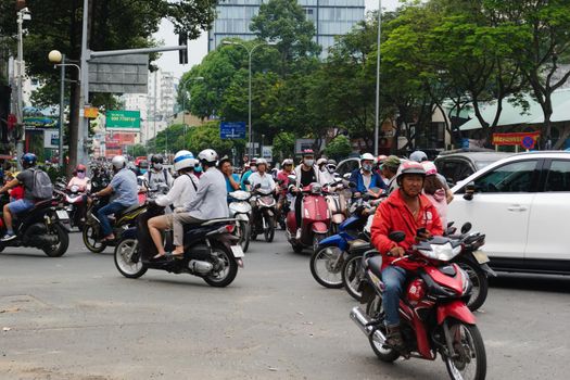 2019-11-10 / Ho Chi Minh City, Vietnam - Urban scene in rush hour. Motorcycles flood the chaotic traffic flow of the city.