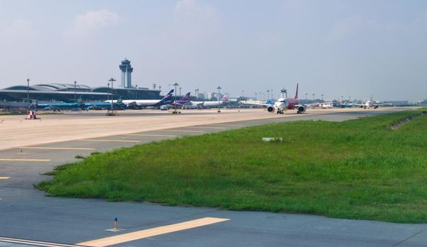 2019-11-14 / Ho Chi Minh City, Vietnam - Airliners queue up in the taxiway of the airport, awaiting authorization to take off.