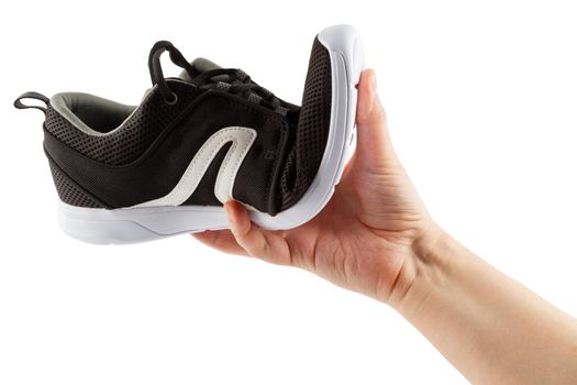 human hand bending lightweight black airmesh summer walking shoes isolated on white background.
